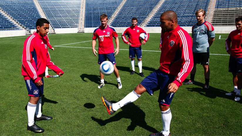 Sam Rodriguez juggles the ball with CJ Brown and Brian McBride
