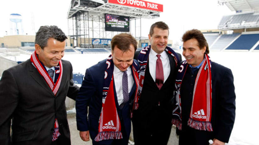 New Fire coach Carlos de los Cobos (far right) greets the Fire brass at Toyota Park in January.