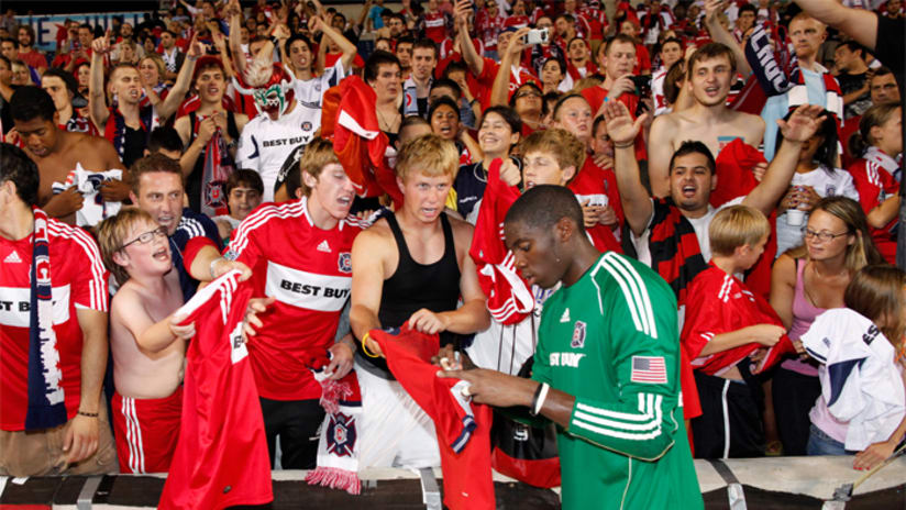 Sean Johnson of the Fire signs autographs after the match