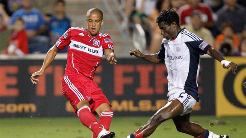 Calen Carr of the Chicago Fire hits the ball away from the defender
