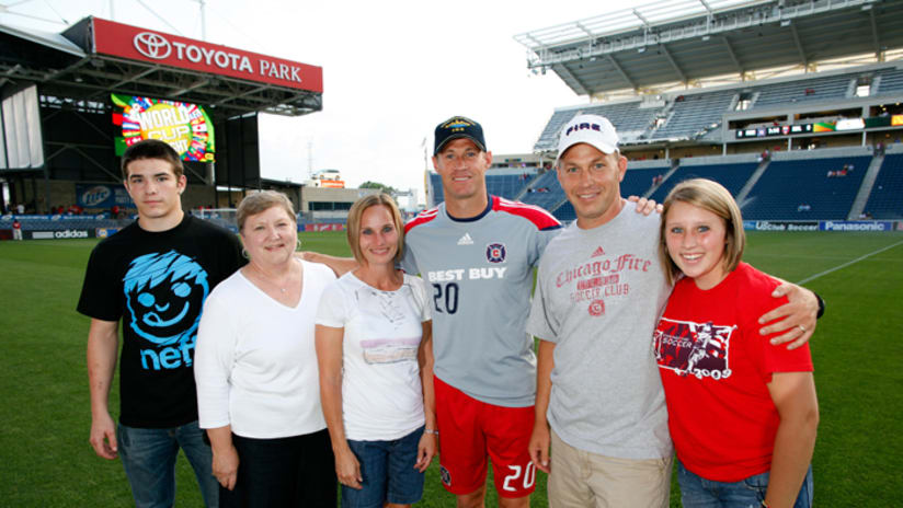 Brian McBride poses for a picture with the Todd Sullivan, and family