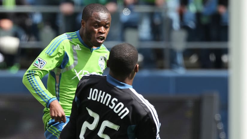 Steve Zakuani #11 of the Seattle Sounders FC scores on goalkeeper Sean Johnson #25 of the Chicago Fire