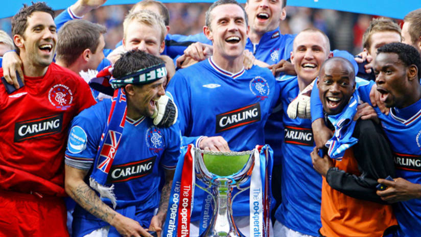 DaMarcus Beasley and Maurice Edu (right) celebrate Glasgow Rangers' latest cup victory