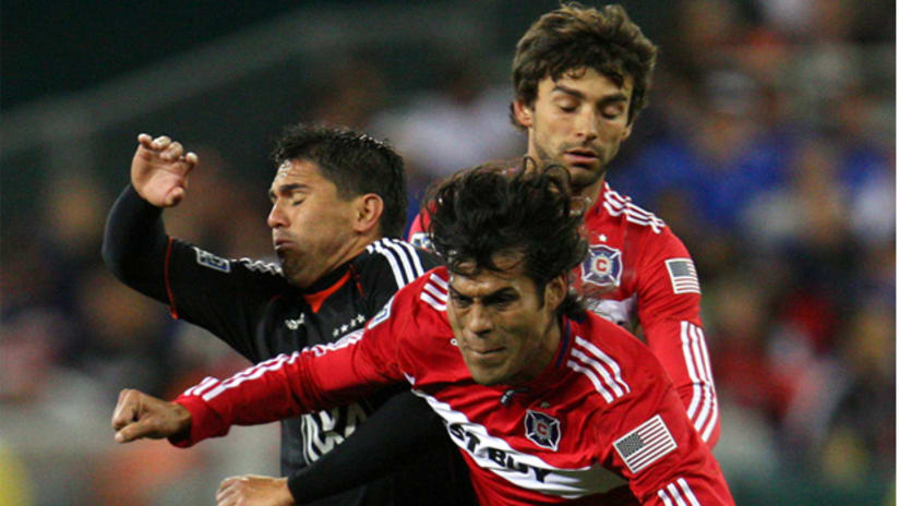 D.C. United's Jaime Moreno gets pushed off the ball by Chicago's Wilman Conde (right) on Saturday night.