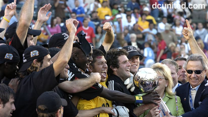 2004: Olsen shares the MLS Cup trophy with teammates and owner Phil Anschutz