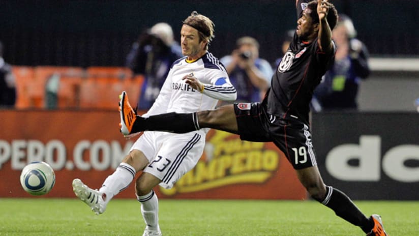 D.C. United's Clyde Simms challenges the Galaxy's David Beckham.