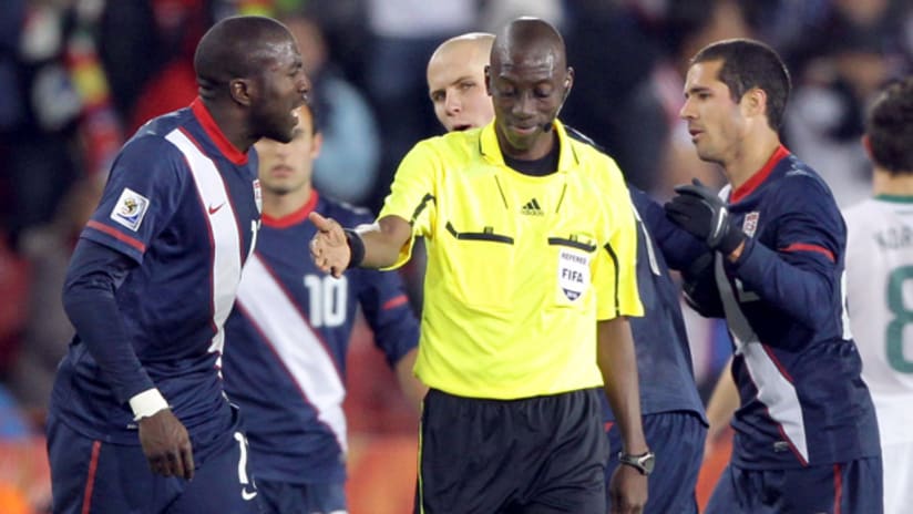 US players argue with Koman Coulibaly after his controversial whistle on Edu's goal.