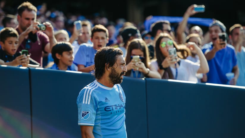 Andrea Pirlo standing in front of fans