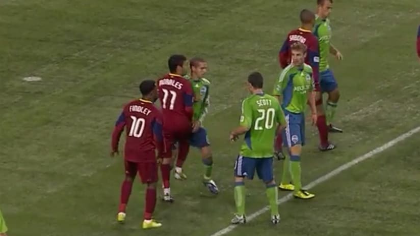 Television cameras catch RSL's Javier Morales sending a knee into Seattle's Osvaldo Alonso