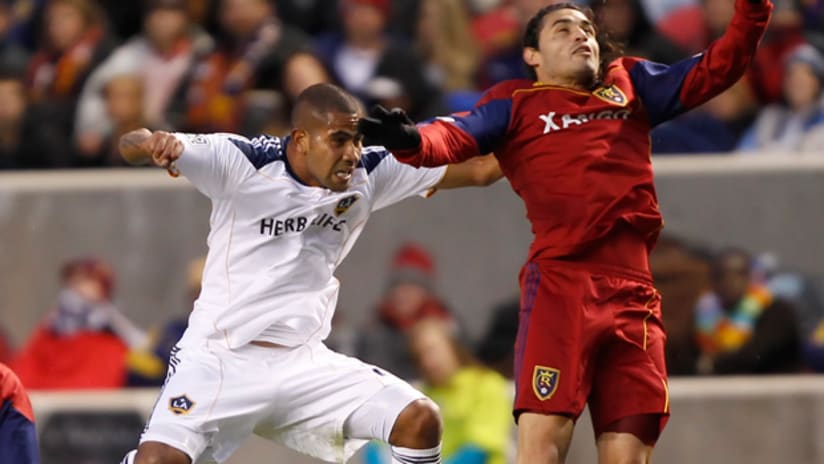 LA Galaxy's Leonardo (left) challenges RSL's Fabian Espindola for a high ball.