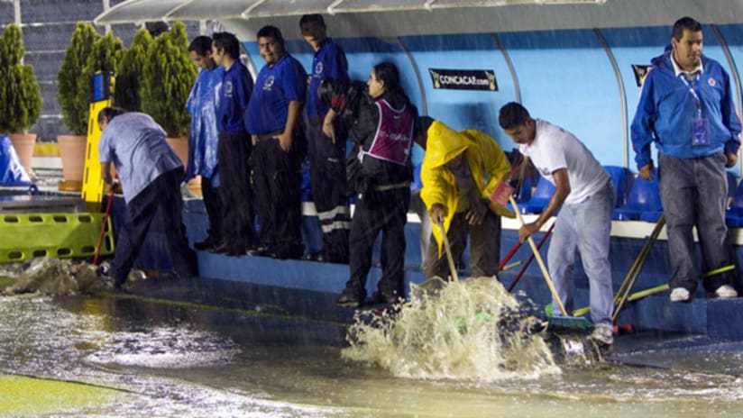 Maintenence crews attempt to clear away the standing water at Estadio Azul on Aug. 25.