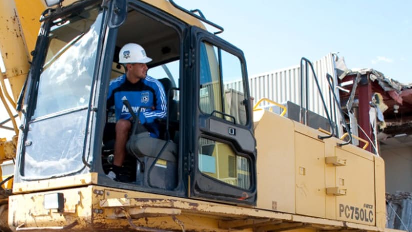 Chris Wondolowski jumps in the excavator's driver's seat as the Quakes began demolition on Thursday.