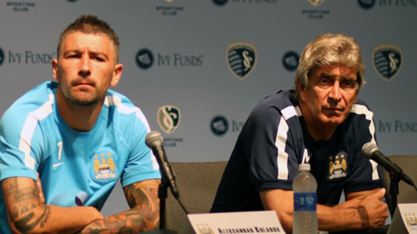 Manchester City Manager Manuel Pellegrini and defender Alex Kolarov