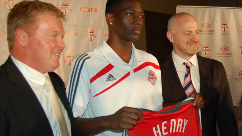 Henry will wear #28. He is flanked by Mo Johnston (left) and Earl Cochrane.