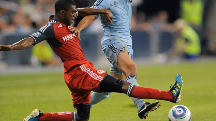 Ashtone Morgan tackles Kansas City's Mexico international Omar Bravo (Lowrance/Getty).
