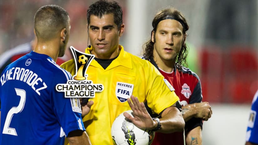 The captains - Daniel Hernandez and Torsten Frings - flank the referee (Paul Giamou/TorontoFC.ca).