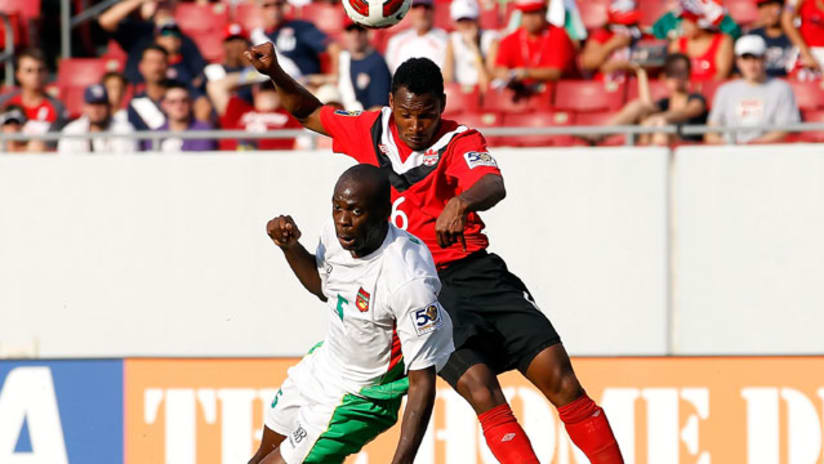 Eddy Viator (in white) jostles for a ball against Julian de Guzman at the 2011 CONCACAF Gold Cup.