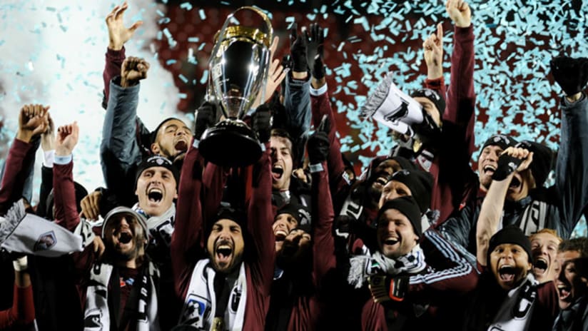 Pablo Mastroeni holds aloft the MLS Cup trophy following Colorado's 2-1 victory after extra time.