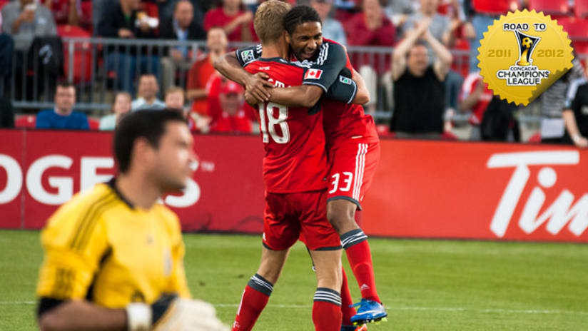 Vancouver's Jay Nolly in the foreground as Nick Soolsma & Javier Martina celebrate (Giamou/TorontoFC.ca)