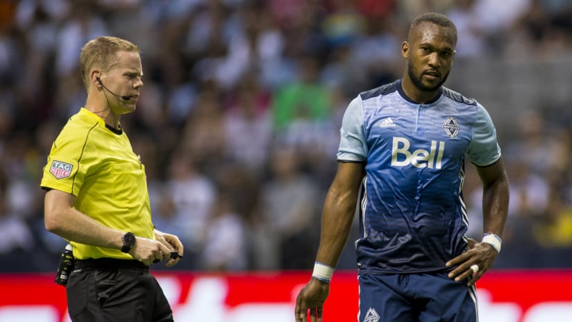 Kendall Waston - blue kit with referee