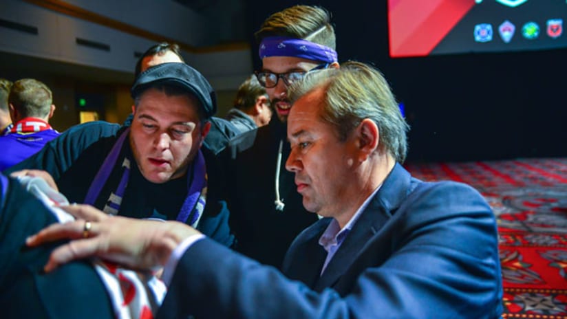 Orlando City head coach Adrian Heath signs autographs for fans at the MLS SuperDraft