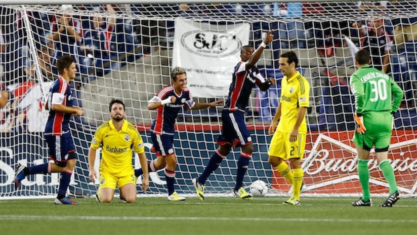 the columbus crew react as the new england revolution and dimitry imbongo celebrate a goal