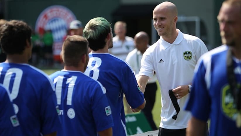 Michael Bradley hands out medals to participants in the Special Olympics Unified soccer game