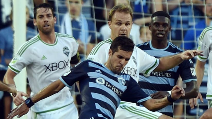 Sporting KC midfielder Benny Feilhaber battles for the ball against Seattle Sounders