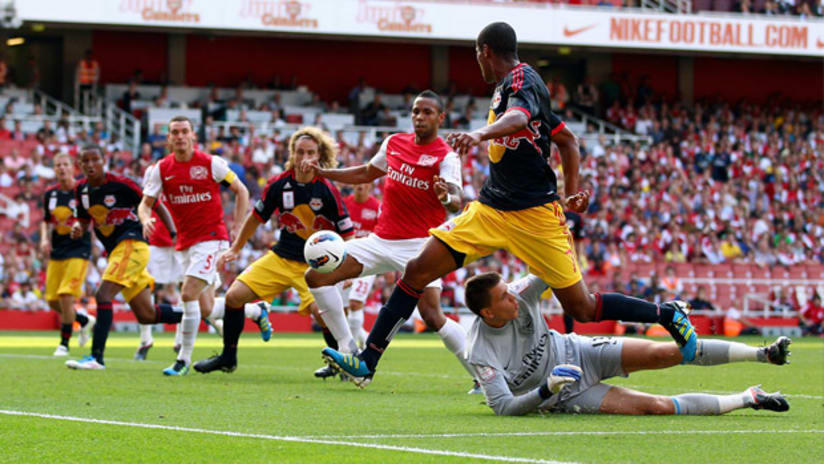 New York's Roy Miller watches on as Arsenal's Kyle Bartley scores an own goal