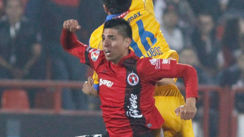 Club Tijuana's Joe Corona battles Tigres' Lucas Lobos