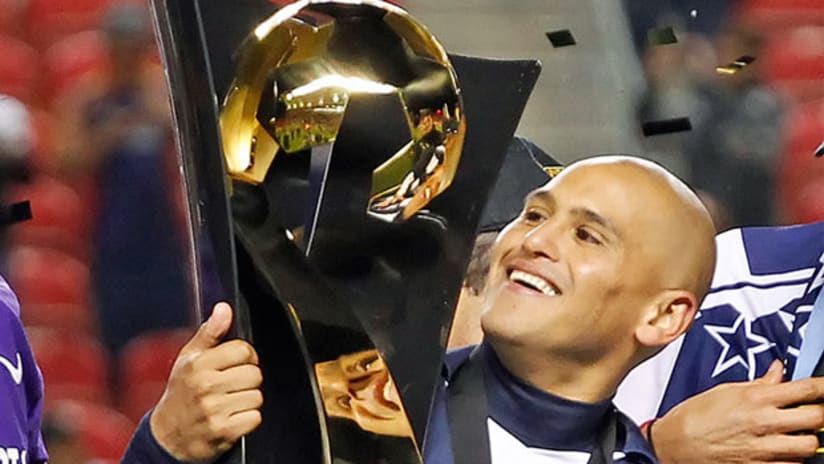 Monterrey's Humberto Suazo embraces the CONCACAF Champions League trophy.