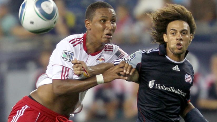 New York's Juan Agudelo (left) vies for the ball against New England's Kevin Alston.