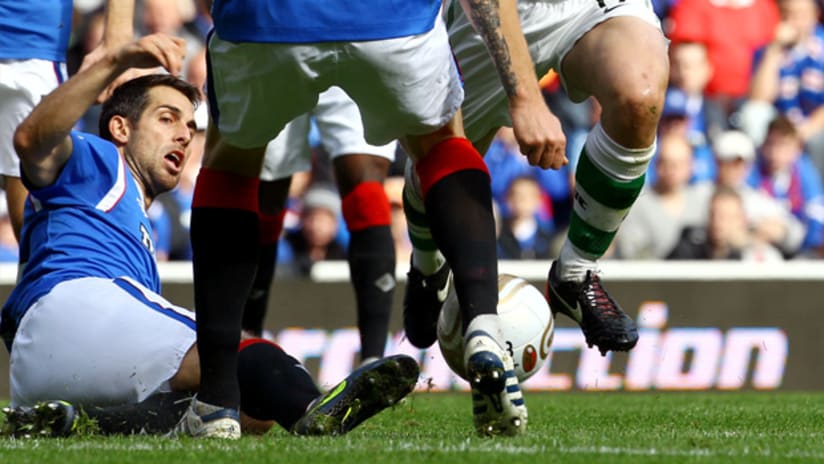 Carlos Bocanegra executes a slide tackle as Rangers beat Celtic.