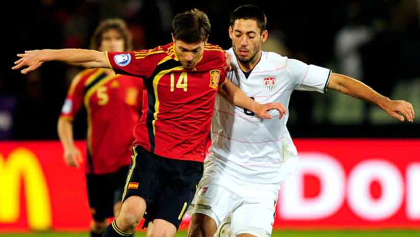 Spain's Xabi Alonso fends off the US' Clint Dempsey during their 2009 Confederations Cup match.