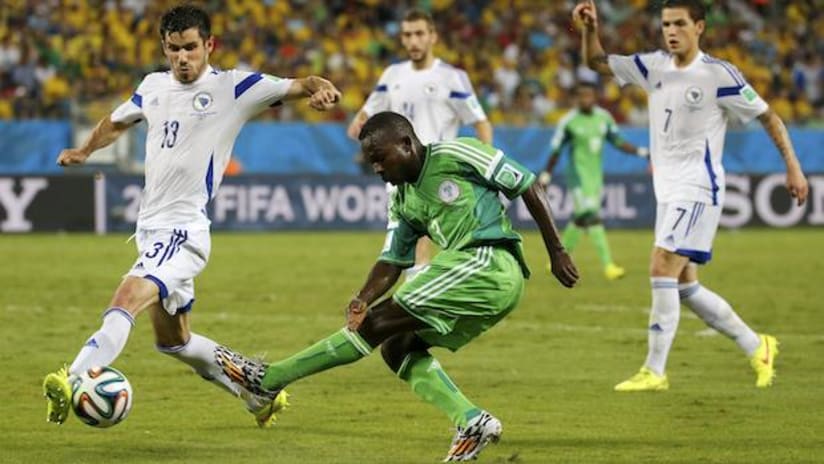 Nigeria's Ejike Uzoenyi shoots past Bosnia's Mensur Mujdza