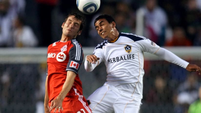 Toronto's Nathan Sturgis and Galaxy's Miguel Lopez go up for a header.