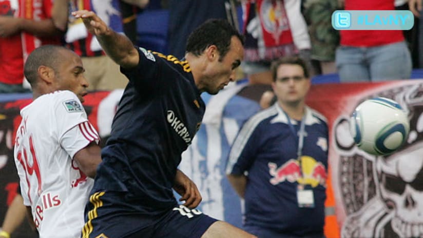 The LA Galaxy's Landon Donovan hustles past Thierry Henry of the New York Red Bulls for a loose ball.