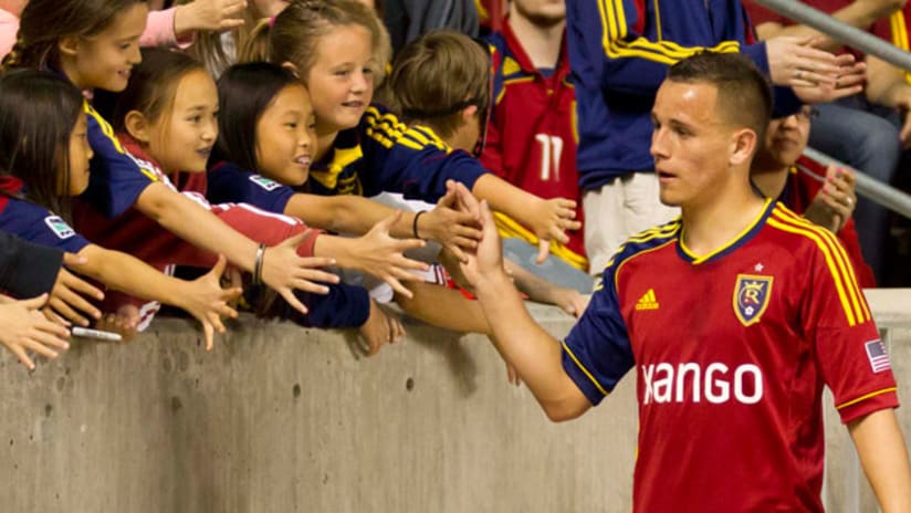 Luis Gil gives high fives to young fans