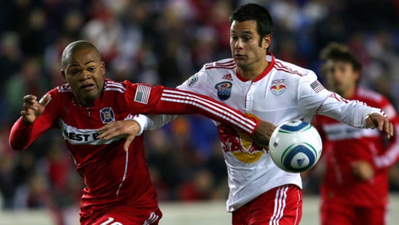 The Fire's Collins John (left) battles with the Red Bulls' Mike Petke on Saturday night at Red Bull Arena.