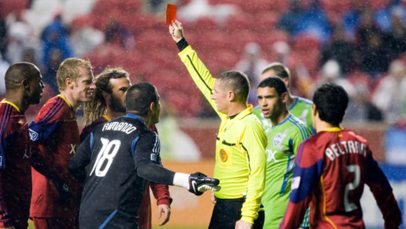 RSL's Jamison Olave is handed a red card for a tackle on Seattle's Mike Fucito.