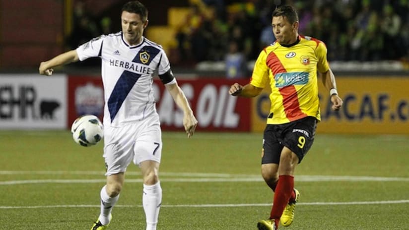 LA Galaxy's Robbie Keane takes the ball past Herediano's Minor Diaz