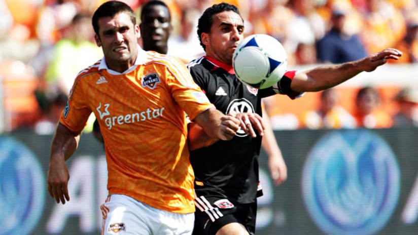 Will Bruin, Houston Dynamo, challenges with Dwayne De Rosario, D.C. United, at BBVA Compass Stadium, May 12, 2012.