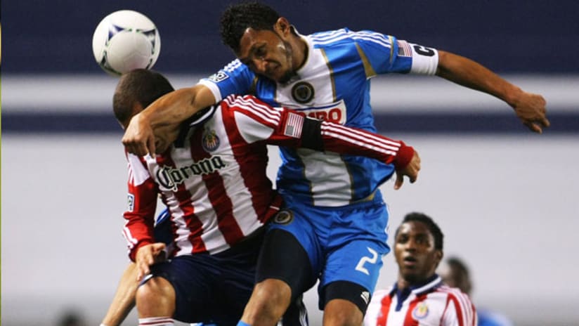 Philadelphia Union's Carlos Valdes clatters into Chivas USA's Alejandro Moreno, April 21, 2012.