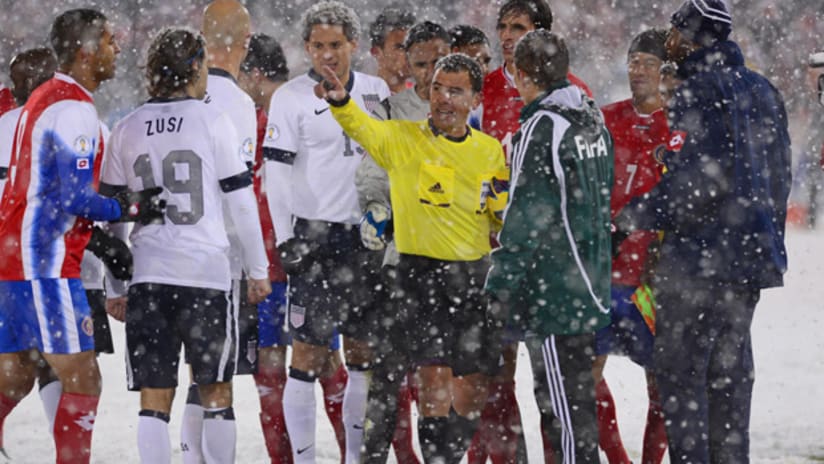US and Costa Rica argue with ref Joel Aguilar in the snow