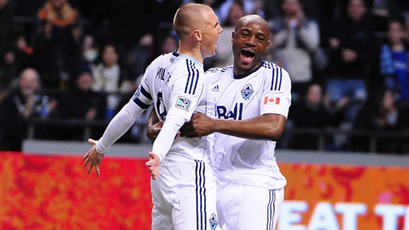 Vancouver Whitecaps Kenny Miller and Nigel Reo-Coker celebrate in 2-1 win over Columbus Crew.