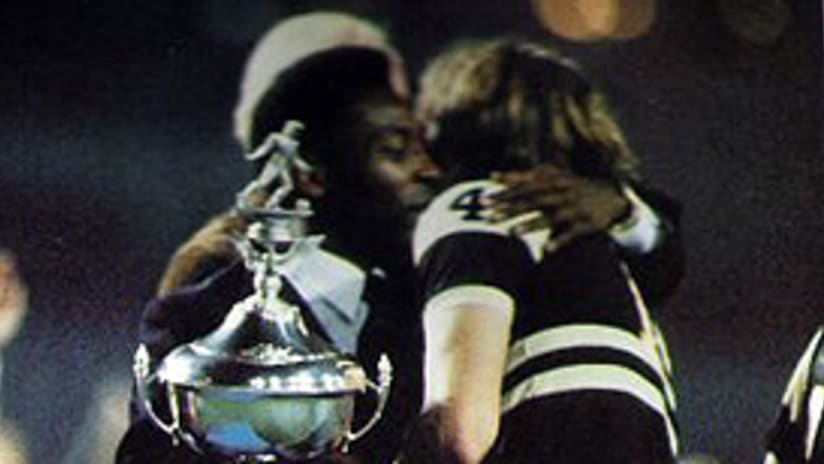 The Chicago Sting's Derek Spalding receives the 1981 Soccer Bowl trophy from Pele.