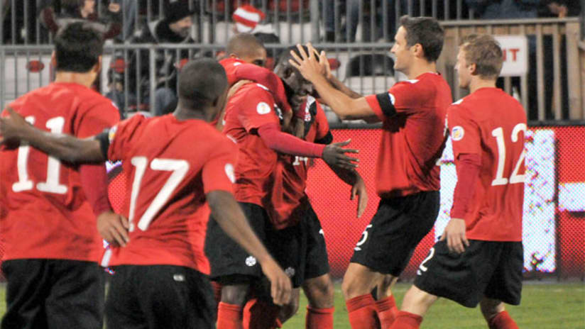 Canada celebrate Olivier Occean's goal vs. St. Kitts and Nevis.