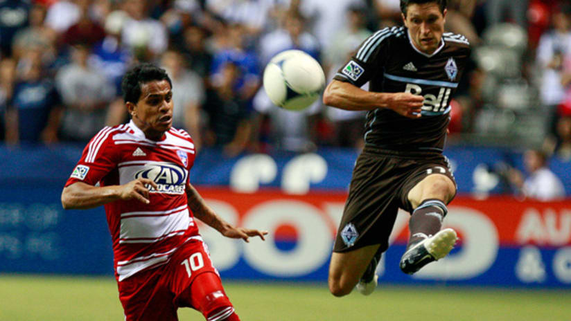 FC Dallas midfielder David Ferreira chases down Vancouver's John Thorrington.