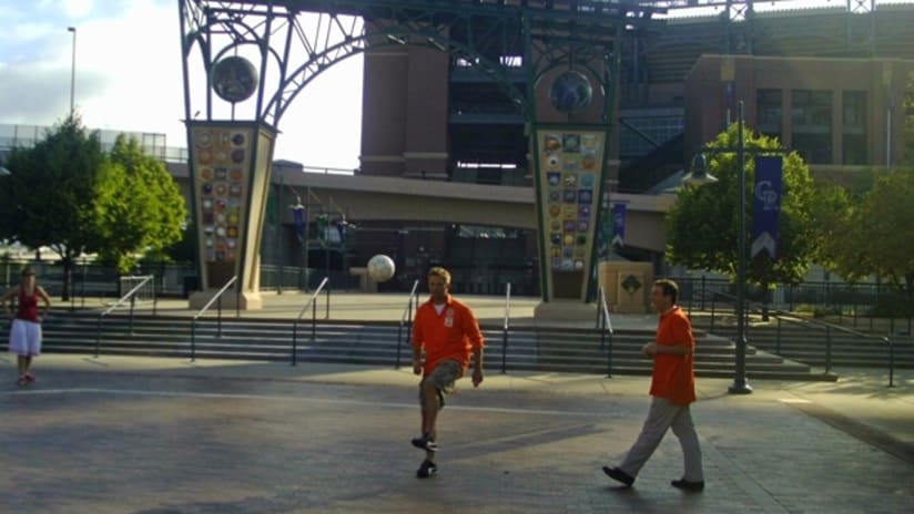 Dutch fans juggle a soccer ball in front of Coors Field in Denver.