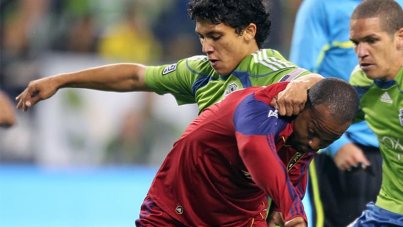 Seattle's Fredy Montero and RSL's Andy Williams vie for possession.